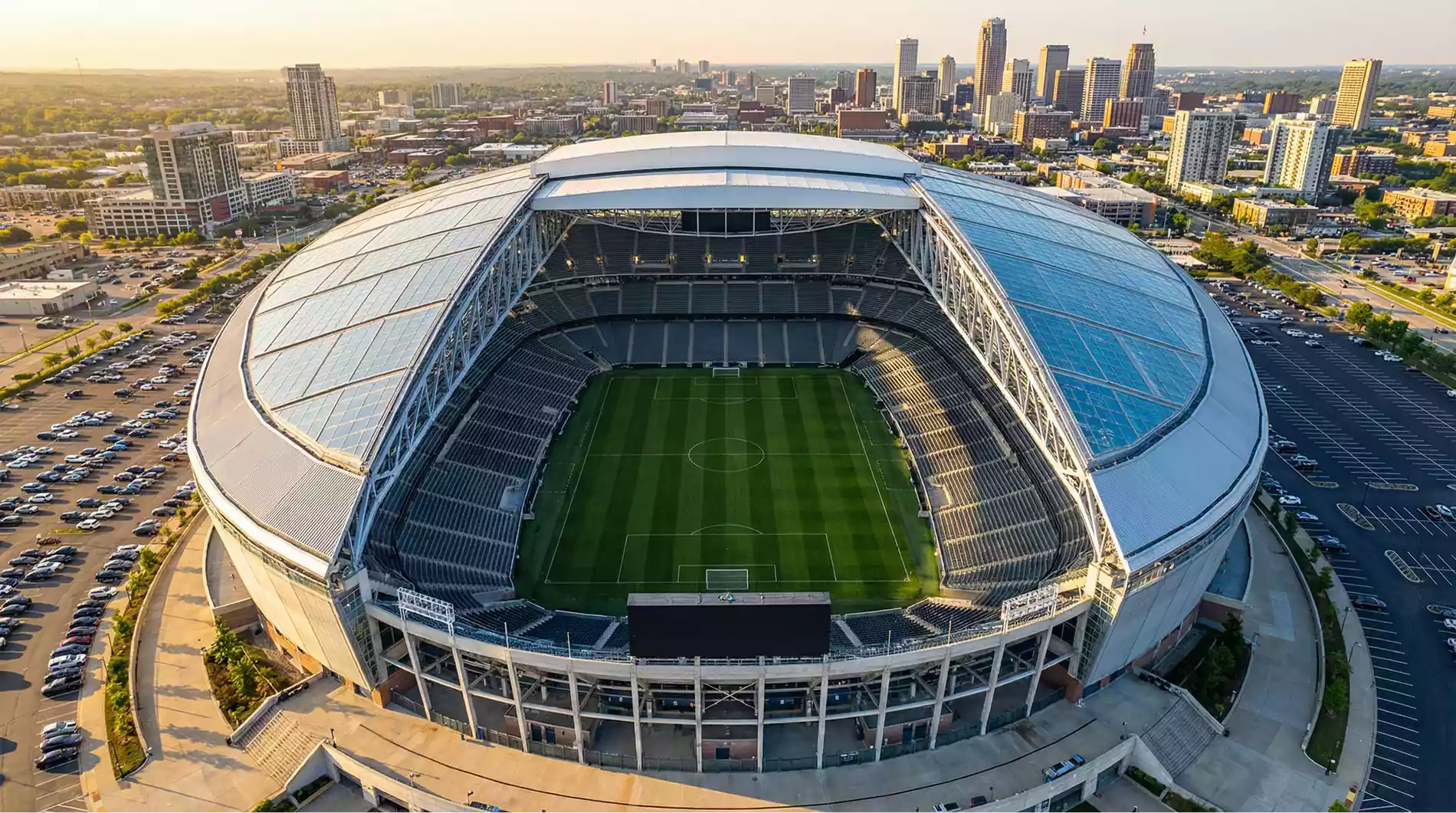 Aerial view of a modern American football stadium converted for a FIFA World Cup 2026 match with a full green pitch and spectator seating